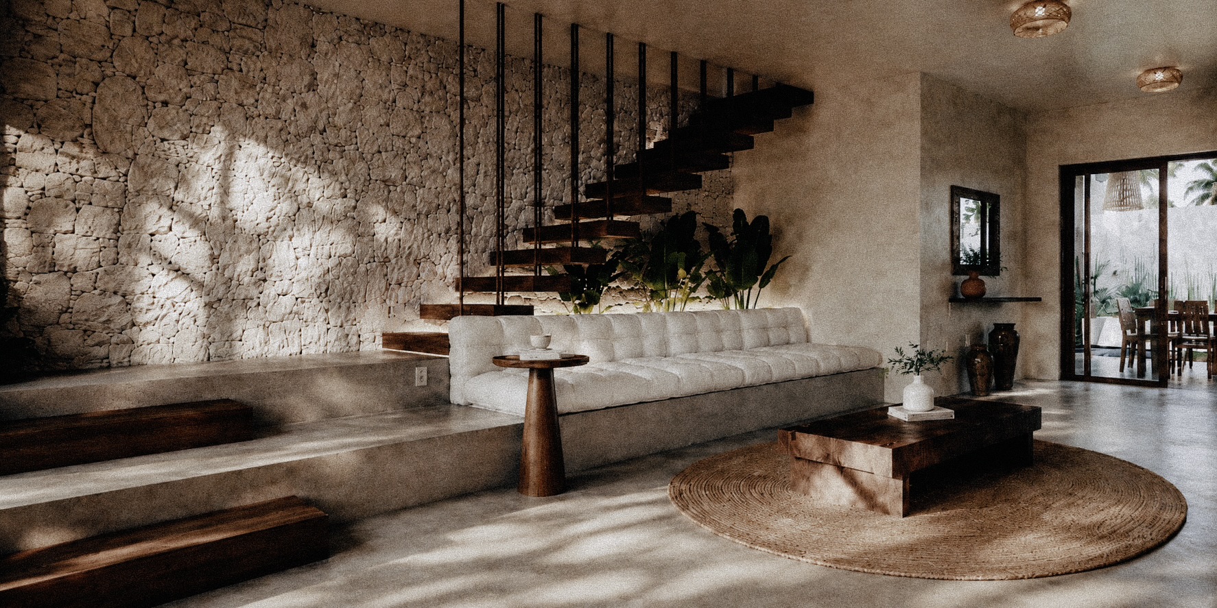 Living room with stone wall, floating staircase and linen sofa